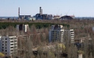 The town of Prypyat is seen against the background of the damaged reactor at the Chernobyl nuclear power plant in Prypyat, Ukraine, Tuesday, April 23, 2013. (AP / Efrem Lukatsky)