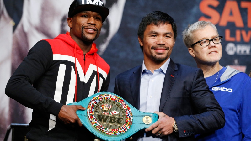 Boxers Floyd Mayweather Jr., left, and Manny Pacquiao pose with a WBC belt during a press conference Wednesday, April 29, 2015, in Las Vegas.  (AP / John Locher)
