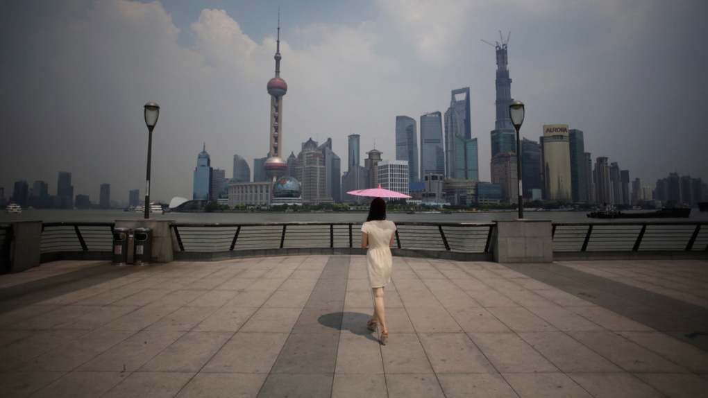 A woman uses a parasol in Shanghai