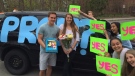 Charlotte Stoody, centre, holds flowers given to her by her boyfriend Devon Oates, left, as part of his promposal in Toronto on Monday, May 4, 2015. (HO - Charlotte Stoody / THE CANADIAN PRESS)