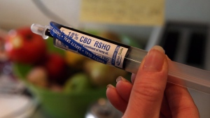 In this April 29, 2014 photo, an oral administration syringe loaded with with high CBD hemp oil for treating a severely-ill child is shown at a private home in Colorado Springs, Colo. (AP/Brennan Linsley)