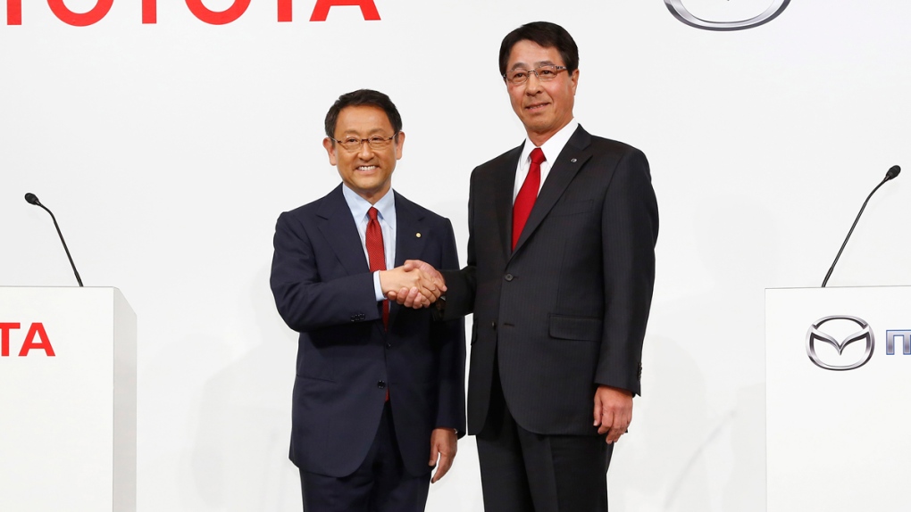 Toyota and Mazda presidents shake hands