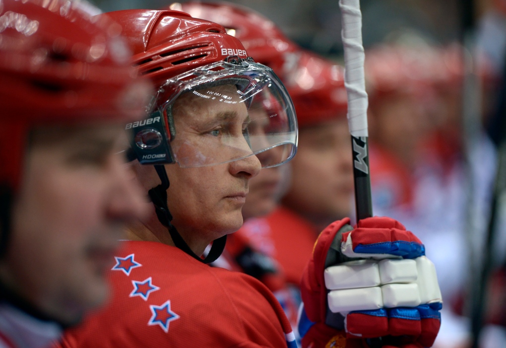Russian President Vladimir Putin plays hockey