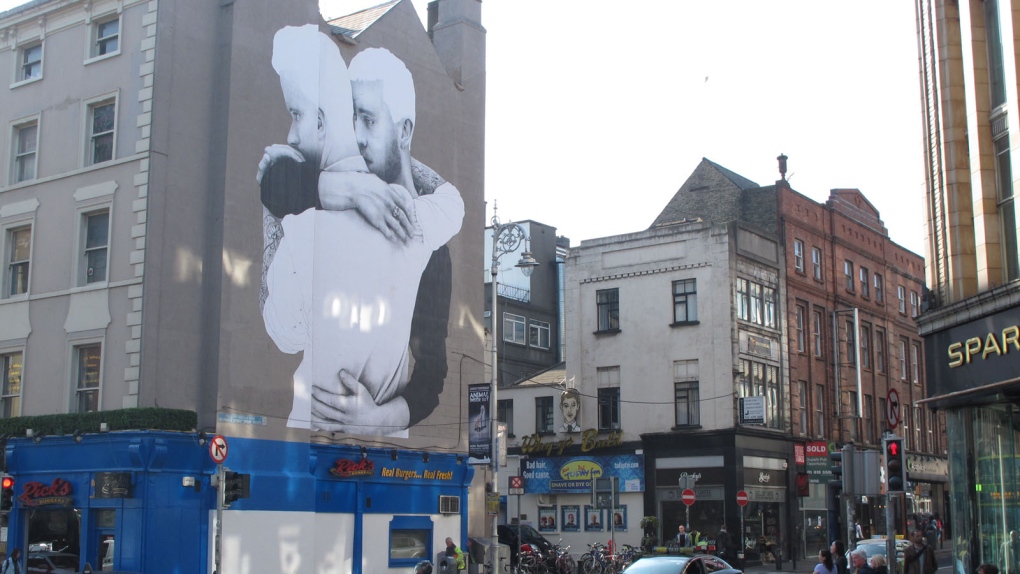A male same-sex couple hug in building poster