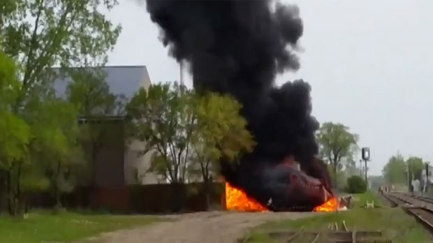 Smoke and flames rise from the explosion behind Ken's Carpets on Archibald in Winnipeg on May 25, 2015 in an image taken from video. ((Richard Schade / MyNews)
