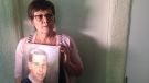 Carol De Delley holds a portrait of her late son Tim McLean.