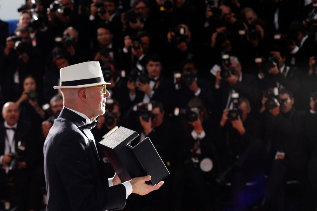 Director Jacques Audiard holds the Palme d’Or