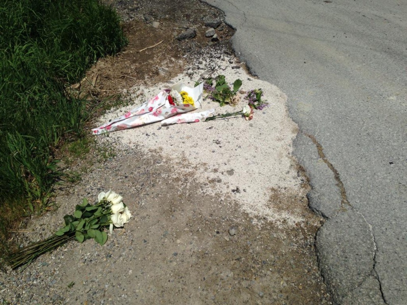 Flower are left at the spot where Jeremy Wickenheiser was killed when a pickup truck hit his motorcycle near Stratford. (Abigail Bimman / CTV Kitchener)