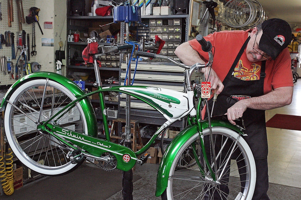Bike shop owner installs headlight on Schwinn