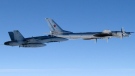 This undated file photo provided by the U.S. Air Force shows a Canadian Air Force F-18 Hornet jet escorting a Russian TU-95 Bear heavy bomber out of Canadian airspace.  (U.S. Air Force photo/Master Sgt. Cecilio M. Ricardo J)