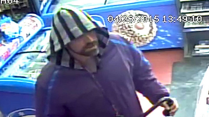 A robbery suspect is shown in a security camera image.