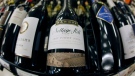 A bottle of Hardys Nottage Hill wine, centre, produced by Constellation Brands, Inc., is shown at Premier Wine & Spirits in Williamsville, N.Y., on Dec. 23, 2010. (David Duprey / AP Photo)