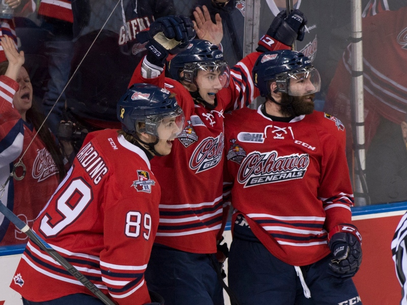 Oshawa Generals forward Anthony Cirelli, centre, is joined by teammates Sam Harding, left, and Bradley Latour, right, after he scored his team's first goal against Kelowna Rockets during second period action at the Memorial Cup final in Quebec City on Sunday, May 31, 2015. (Jacques Boissinot /The Canadian Press)