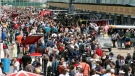 Race fans crowd pit lane during the open house day at Circuit Gilles Villeneuve for the Canadian Grand Prix Thursday, June 4, 2015 in Montreal. (THE CANADIAN PRESS/Ryan Remiorz)