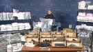 Toronto Police Const. Caroline de Kloet stands behind a display of items seized in southern Ontario raids conducted on Thursday, June 4, 2015. 
