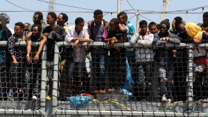 Migrants wait to disembark from the German Navy ship Hessen at the Palermo harbor, Italy on June 7, 2015. European rescue boats are bringing thousands of migrants saved at sea to Italian ports, prompting center-right politicians to vow that their regions won't shelter any more of them. (AP / Alessandro Fucarini) 