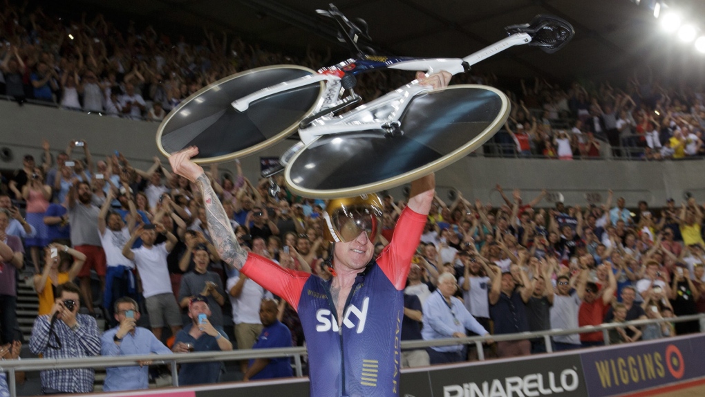 Wiggins holds up bicycle after win