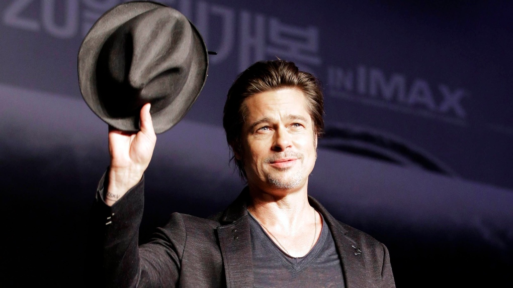 Brad Pitt waves his hat