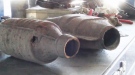 A pair of catalytic converters are shown. 