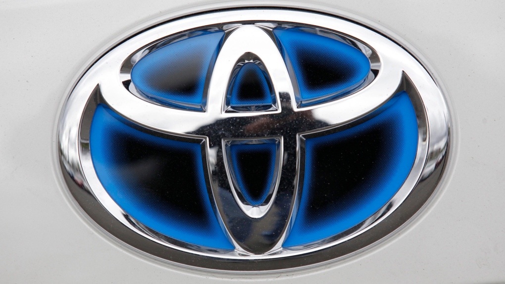 A Toyota logo is shown on a Prius 