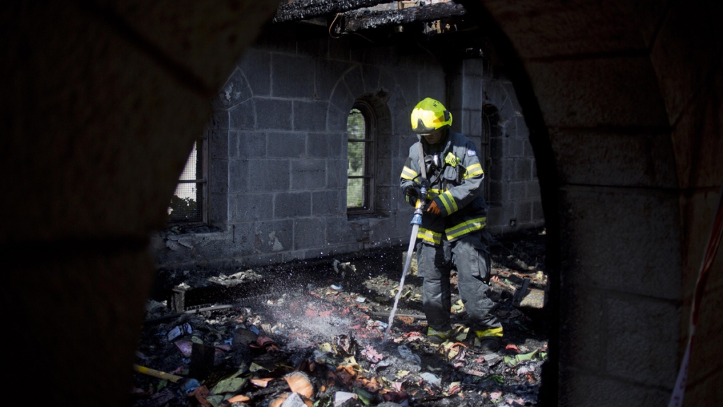 An Israeli firefighter at scene of a church fire