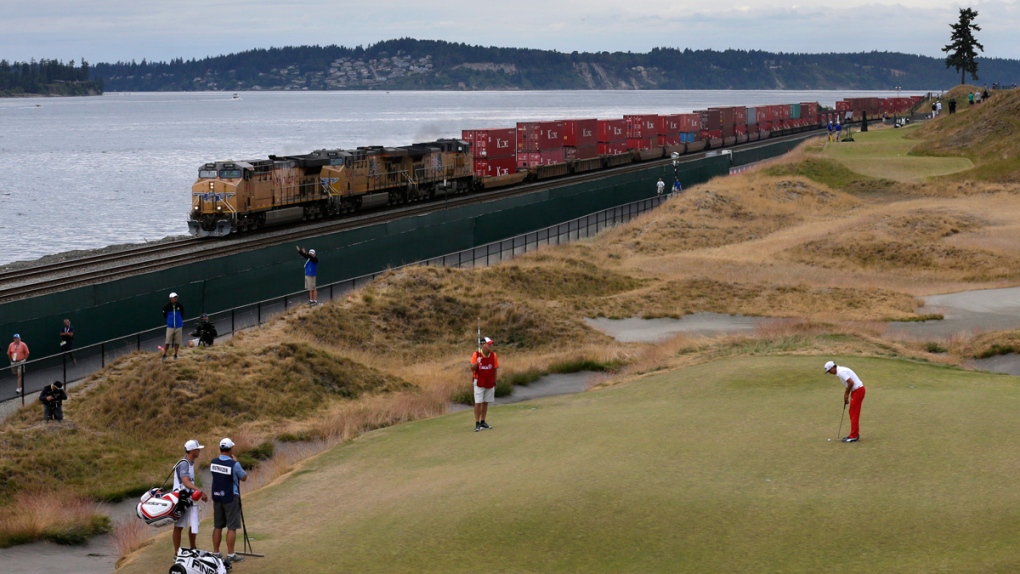 A train rumbles past the U.S. Open golf tournament