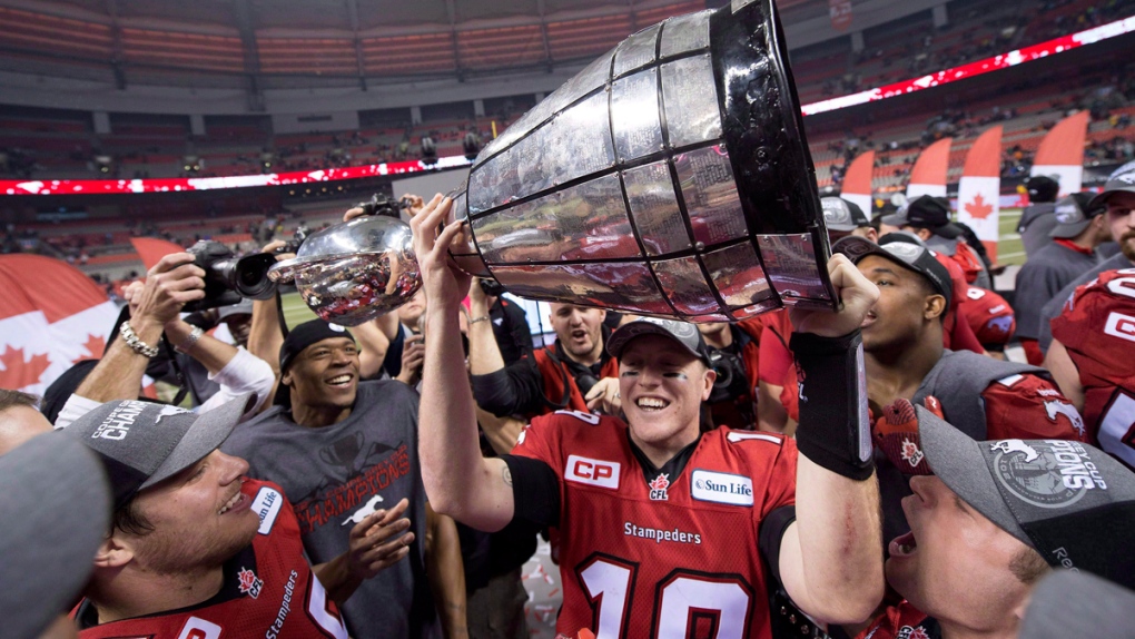 Bo Levi Mitchell hoists the Grey Cup
