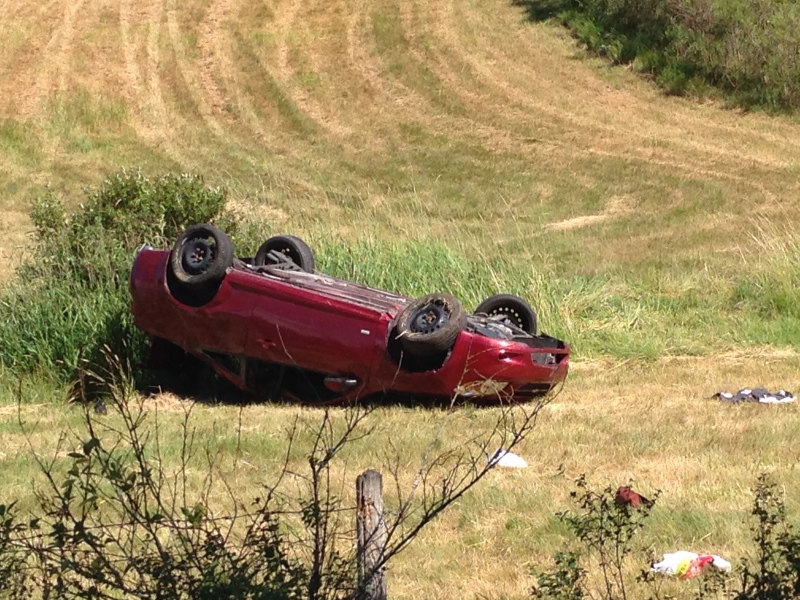 Three young people were rushed to hospital on spinal boards after their car went off the road, flipping over in a farmer’s field in Saanich Friday, June 19, 2015. (CTV Vancouver Island)