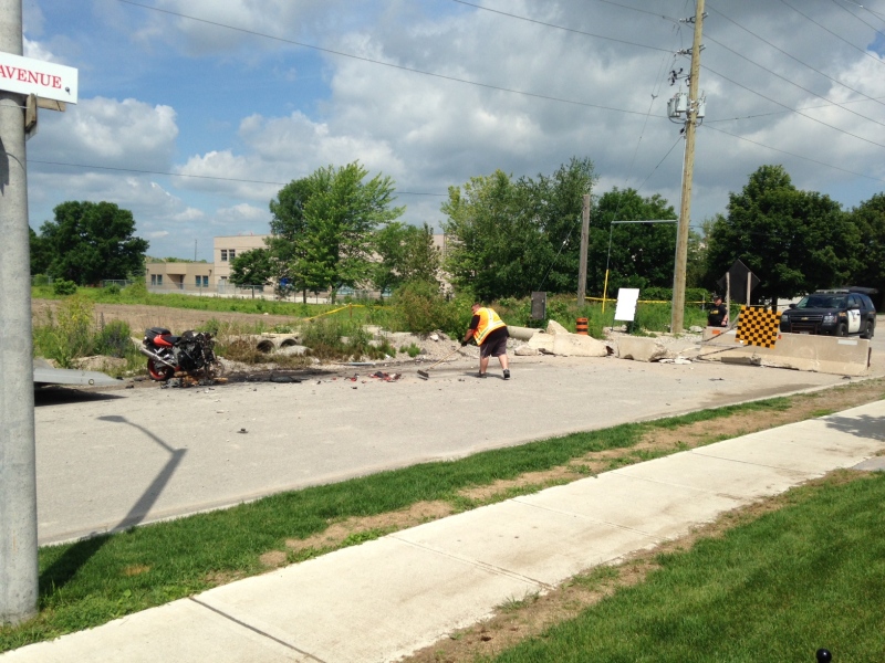 Investigators can be seen at the scene of a fatal motorcycle crash in Alliston, Ont. on Sunday, June 21, 2015. (Steve Mansbridge/ CTV Barrie)