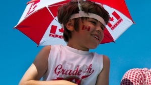 An unidentified youth watches a Canada Day parade in Halifax on Sunday, July 1, 2012. (Andrew Vaughan / THE CANADIAN PRESS)
