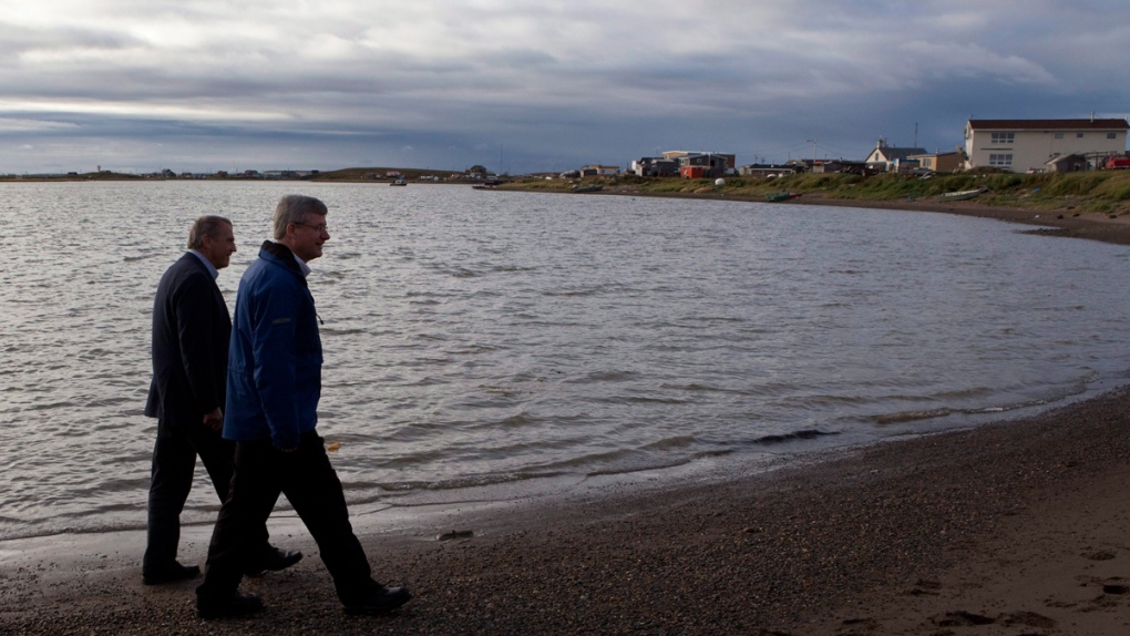 PM Harper, right, on the shore of the Beaufort Sea