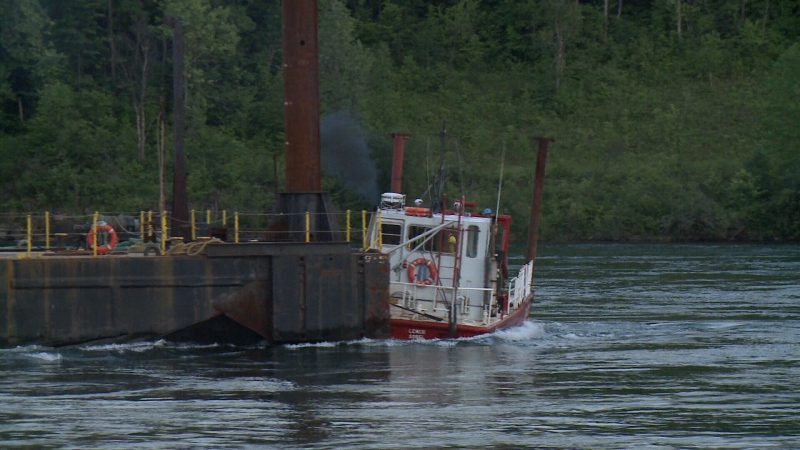 A second tugboat is pulled under by the current of the St. Lawrence river after attempting to stabilize a barge being used for the demolition of the Seaway International bridge in Cornwall (Dave Charbonneau/CTV Ottawa, June 22, 2015)