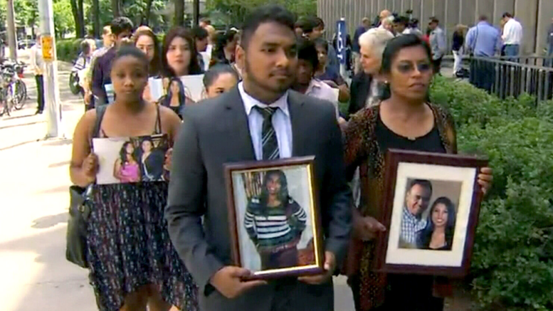 The family of a father and daughter killed in a wrong-way crash walk out of the courthouse with pictures on June 26.