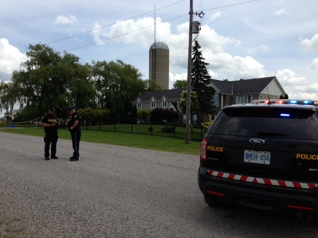 OPP investigators remain outside a home on Westminster Drive a day after 51-year-old Robert St. Denis was found dead near London, Ont., Friday, June 26, 2015. (Nick Paparella / CTV London)