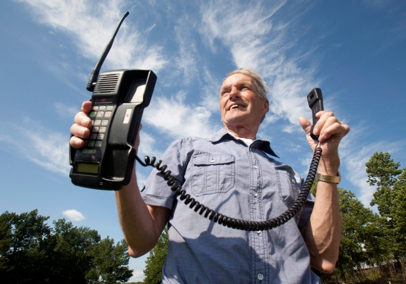 Victor Surerus poses for a photo at his farm in Roseneath, Ontario, on Wednesday, June 24, 2015 with the first cell phone in Canada. (Fred Thornhill / THE CANADIAN PRESS)