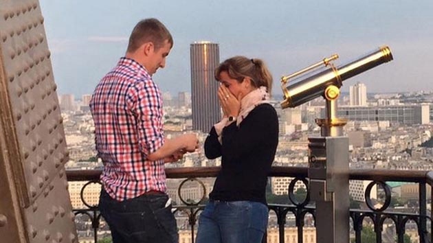 Couple engaged on Eiffel Tower