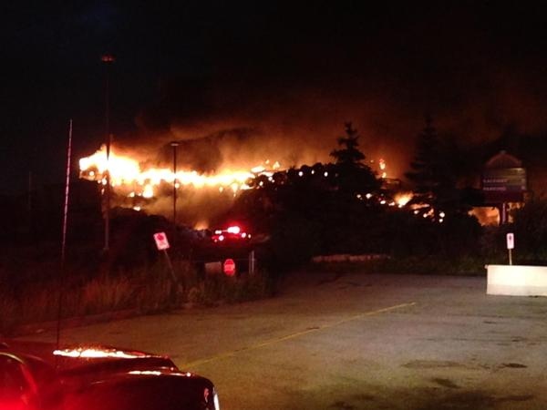 Large flames can be seen coming from the former Windsor Raceway on Wednesday, July 1, 2015. (Rob Hindi / AM800)