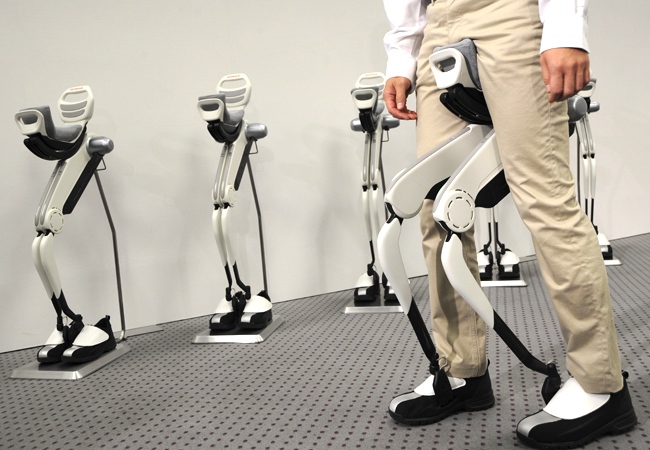 A researcher displays Honda Motor Co.'s experimental walking assist device with bodyweight support system as the device is unveiled in Tokyo Friday, Nov. 7, 2008. (AP / Katsumi Kasahara)