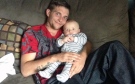 Dylan Debreau, 23, is seen with his five-month-old son in this photo provided by his family.