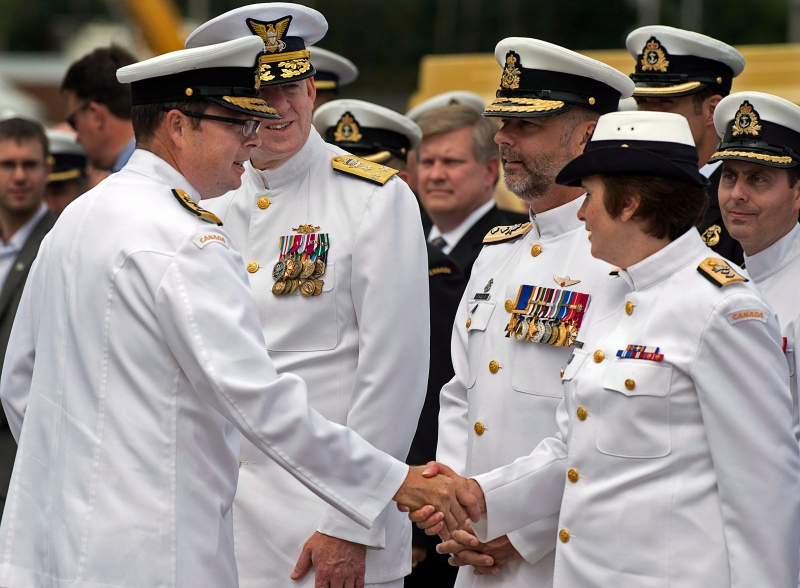 Vice Admiral Mark Norman, left, greets officers at a change of command ceremony in Halifax on Friday, July 12, 2013. (Andrew Vaughan/The Canadian Press)