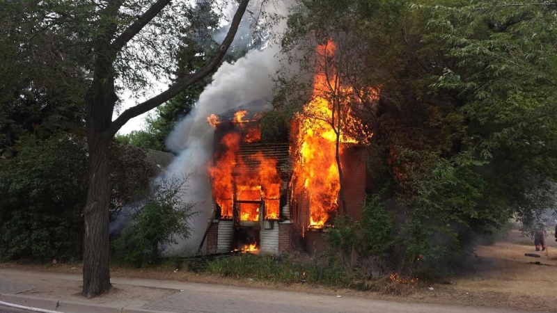 A house at 1317 Idylwyld Drive burns in Saskatoon on Saturday, July 11, 2015. (Twitter/@SaskatoonFire)