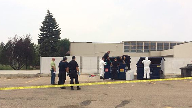 RCMP were searching through dumpsters by Red Deer Lodge after a man's body was found on 49th Avenue. 
