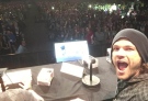 Actor Jared Padalecki takes a photo as audience members at a Comic-Con event hold up candles in his honour. 