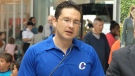 Minister of Employment and Social Development Pierre Poilievre wears a Conservative Party golf shirt during an announcement on child care benefit payments, in Halifax, Monday, July 20, 2015.