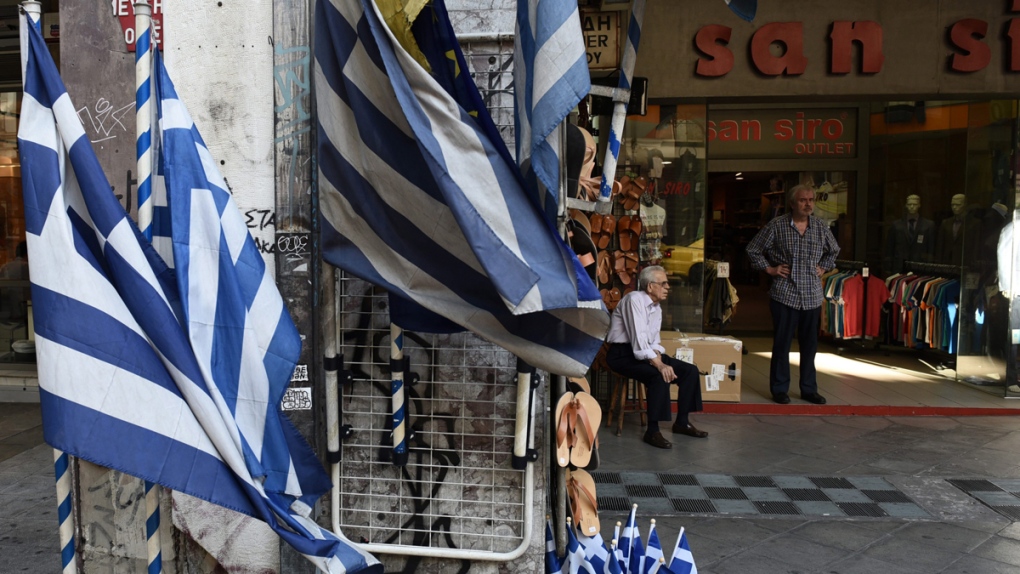 Shop owners wait for customers in Athens, Greece