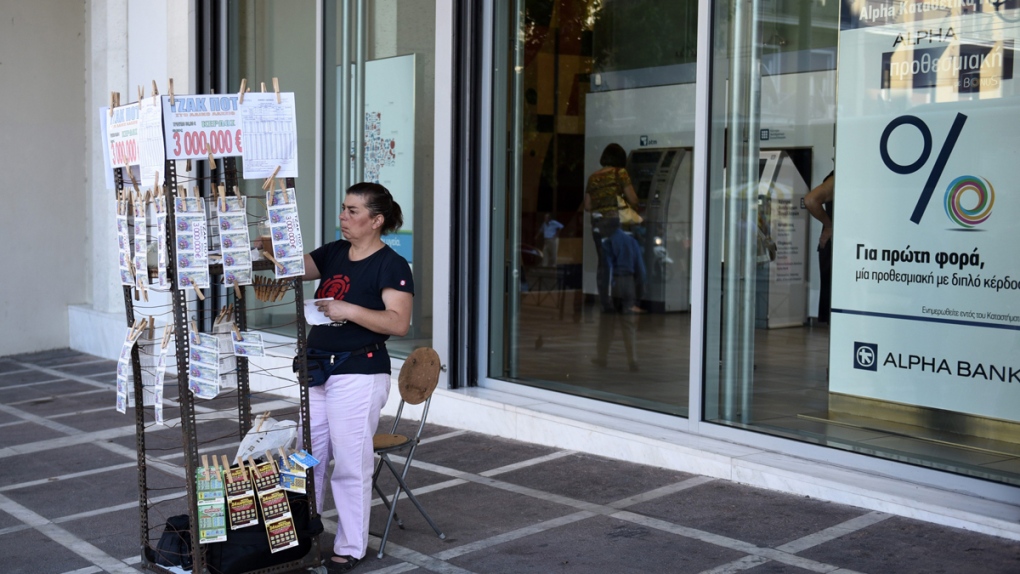 Selling lottery tickets outside a bank in Athens