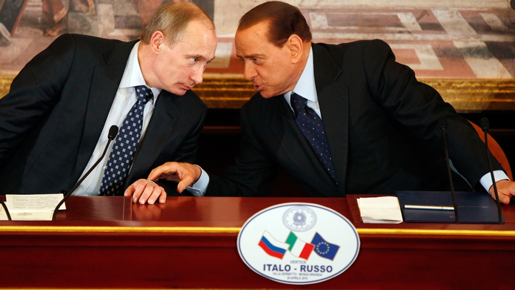 Silvio Berlusconi speaks with Vladimir Putin
