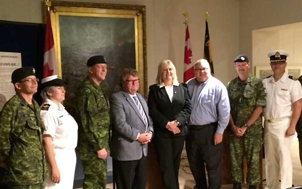 MPs Ed Holder and Susan Truppe, centre, pose for a photo at the Wolseley Barracks in London, Ont. on Monday, July 27, 2015. (Office of MP Susan Truppe)