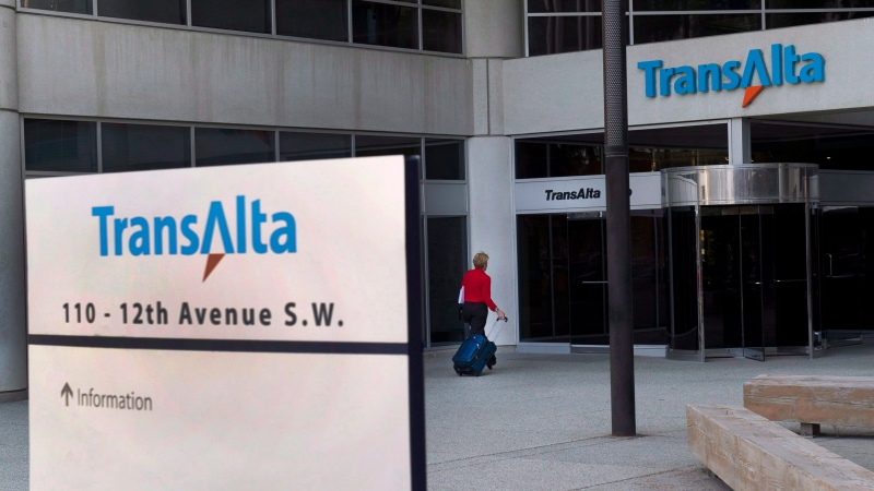 A woman walks towards the entrance of the TransAlta headquarters building in Calgary, on Tuesday, April 29, 2014. (Larry MacDougal / THE CANADIAN PRESS)