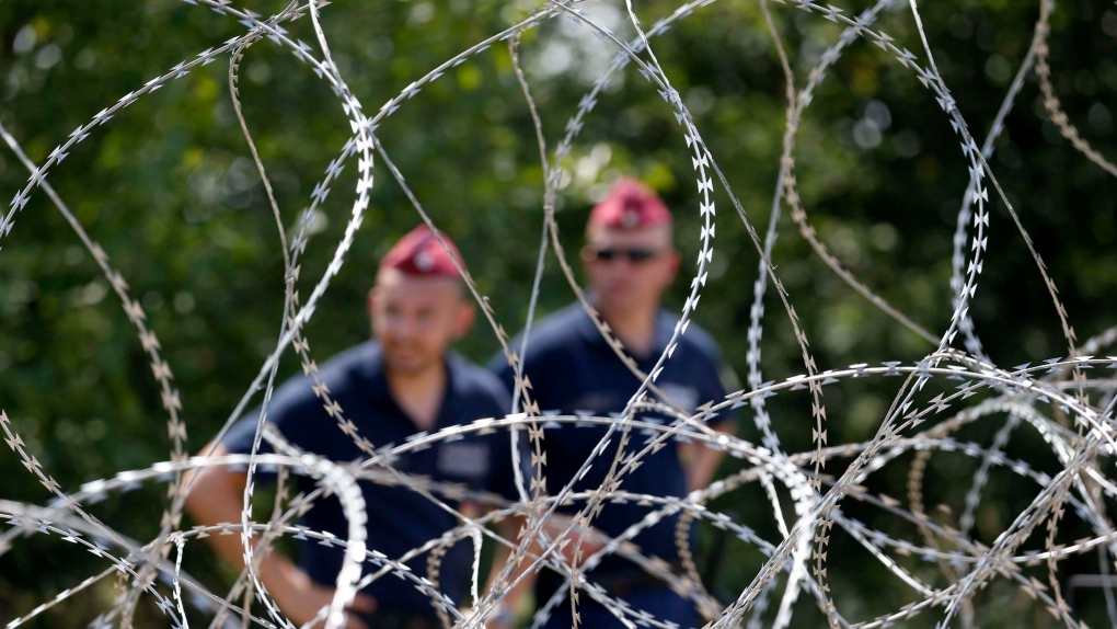 Hungary officers at border fence